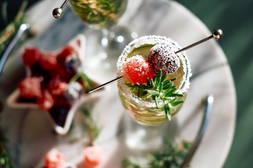 Christmas Cocktail with sparkling wine, rosemary, and cherry